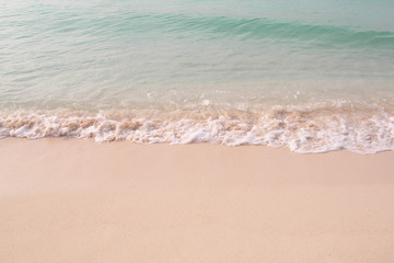 Small waves reaching the shore of the beach