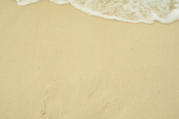 Small waves reaching the shore of the beach
