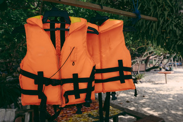 Close-up group of Life jacket or life vest hanging under the shelter at Pangkor Island, Malaysia