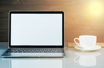 Laptop mockup and coffee cup with wood background on the work table