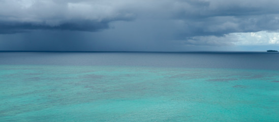 Fototapeta na wymiar Tropical angry dark blue rain storm is approaching quickly over Indian ocean near Banyak islands, Sumatra. Perfect but still undiscovered holiday destination