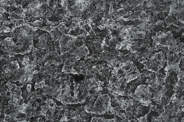 Texture of black rice paper with white streaks on it. Rice paper with creases cracks and spots. Textured paper background.