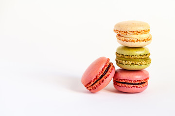 Assortment of delicious traditional french macaroons. Colorful sweet dessert for real gourmands. White background, copy space, close up, macro.