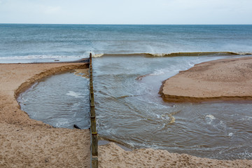 Meggies Burn, a small river leaving the beach and flowing into the sea after being re-routed...