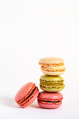 Assortment of delicious traditional french macaroons. Colorful sweet dessert for real gourmands. White background, copy space, close up, macro.