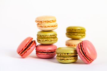 Assortment of delicious traditional french macaroons. Colorful sweet dessert for real gourmands. White background, copy space, close up, macro.