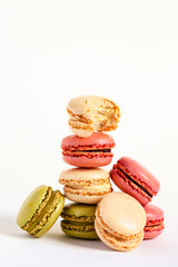 Assortment of delicious traditional french macaroons. Colorful sweet dessert for real gourmands. White background, copy space, close up, macro.