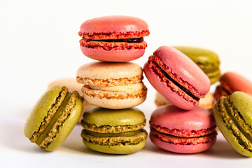 Assortment of delicious traditional french macaroons. Colorful sweet dessert for real gourmands. White background, copy space, close up, macro.
