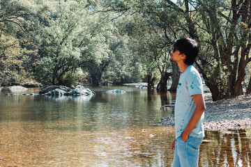 Portrait of an Indian man standing in front of river in the Polo Forest in Gujarat, India