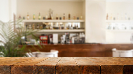 Sunny summer day and blurred interior of restaurant with bar. 