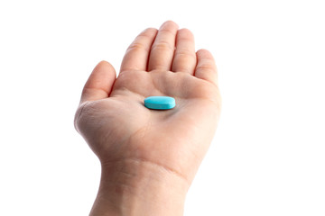Fototapeta premium Blue vitamine in palm hand. medicines and vitamins