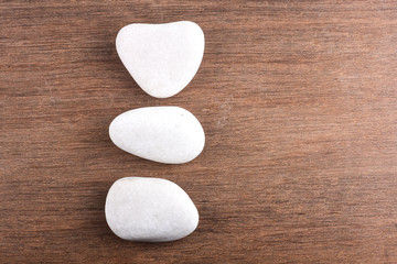 White stones on wooden background