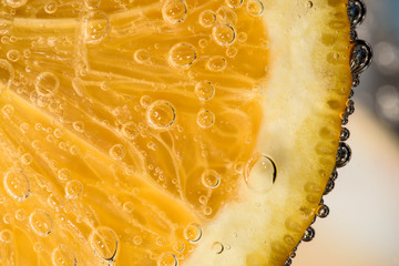 Detail of orange slice in sparkling water © Petr
