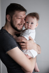 Portrait of a small child in the arms of his father..