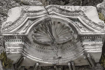 Part of the interior of an ancient ruined temple. Elaborate stone carvings. Greek culture.