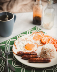 Longsilog is a famous Filipino breakfast that typically consists  of  a processed meat similar to a sausage (called longganisa),  fried rice and eggs. Finally, garnished with some sliced tomatoes.
