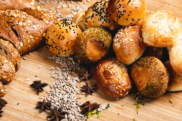 A spread of buns  showered with a variety of grains