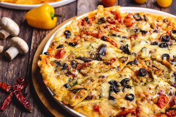 Freshly baked Supreme Pizza loaded with meat, cheese, peppers, olives and herbs
