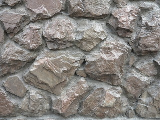 the wall is lined with natural stone on the ground façade