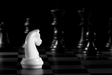 white knight chess piece on the board background