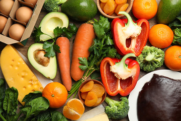 Fresh products rich in vitamin A on table, flat lay