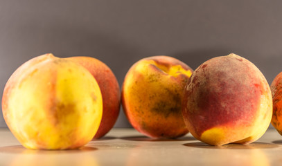 Fototapeta na wymiar Fresh Peach Fruit (Prunus persica) on a flat surface