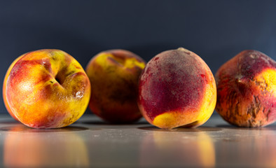 Fototapeta na wymiar Fresh Peach Fruit (Prunus persica) on a flat surface