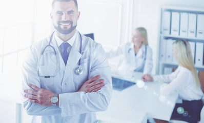 Happy doctor with medical staff at the hospital