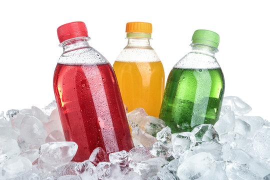 Ice cubes and different soda drinks on white background