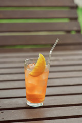 cocktail with orange juice and a slice of orange with a straw