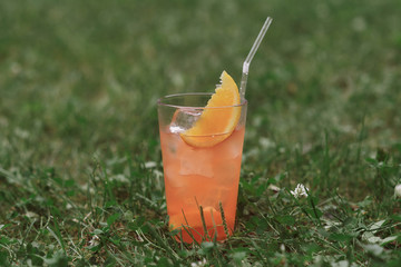 cocktail with orange juice and a slice of orange with a straw