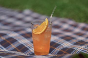 cocktail with orange juice and a slice of orange with a straw
