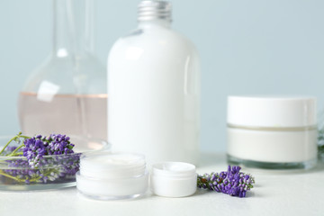 Fototapeta na wymiar Herbal cosmetic products, laboratory glassware and ingredients on white table