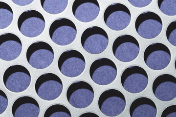 Steel plate with holes. metal grid with round cells. modern background. iron mesh close up