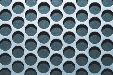 Steel plate with holes. metal grid with round cells. modern background. iron mesh close up