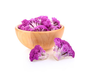 Purple cauliflower in wooden bowl on white background