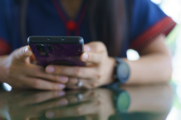 Woman using a smartphone while waiting for food