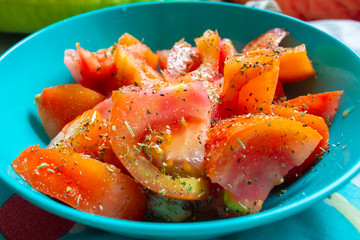 Tomato salad dressed with oregano, oil, vinegar and salt