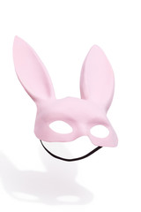 Subject shot of a pink velvet bunny mask with long ears with a black elastic strap for easy wear. The mask for costume party is isolated on the white background.