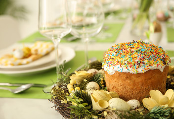Festive table setting indoors, focus on traditional Easter bread