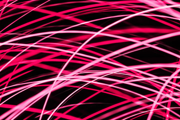 Pink glowing lines background. Modern art long exposure neon lights. Weekend party backdrop. Dynamic stripes motion texture. Speed of light futuristic modern wallpaper.
