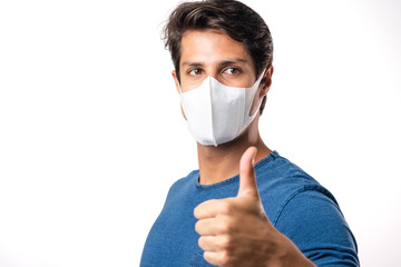 Handsome man brazilian showing okay gesture. Photo of healthy man wears protective mask against infectious diseases and flu. Health care concept.Mask prevent Covid 19 OK Leave space White background