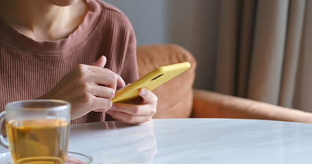 Woman use of mobile phone at home