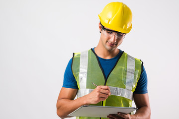 Portrait of Technician service man wear Mechanic set and cap with clipboard on hand ,service business ,maintenance and people concept Check Construction work Put safety equipment on white background.
