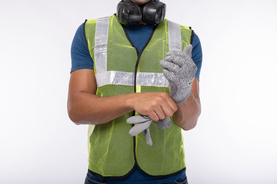 Technician Brazil wearing gloves mechanic Get ready to work Wearing safety equipment Before work Cut resistant gloves White backdrop