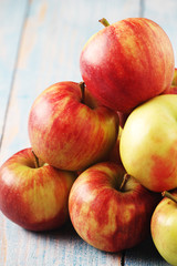 Several ripe red apples on the wooden table	