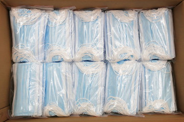 Obraz na płótnie Canvas Due to the shortage of medical supplies due to the COVID-19 Coronavirus epidemic, there are many medical masks in boxes ready for shipment