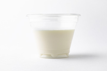 Dessert delicious pudding, panacota or jelly made from vanilla, jam and chocolate package in a plastic cup for take away or food delivery isolated on a white background.