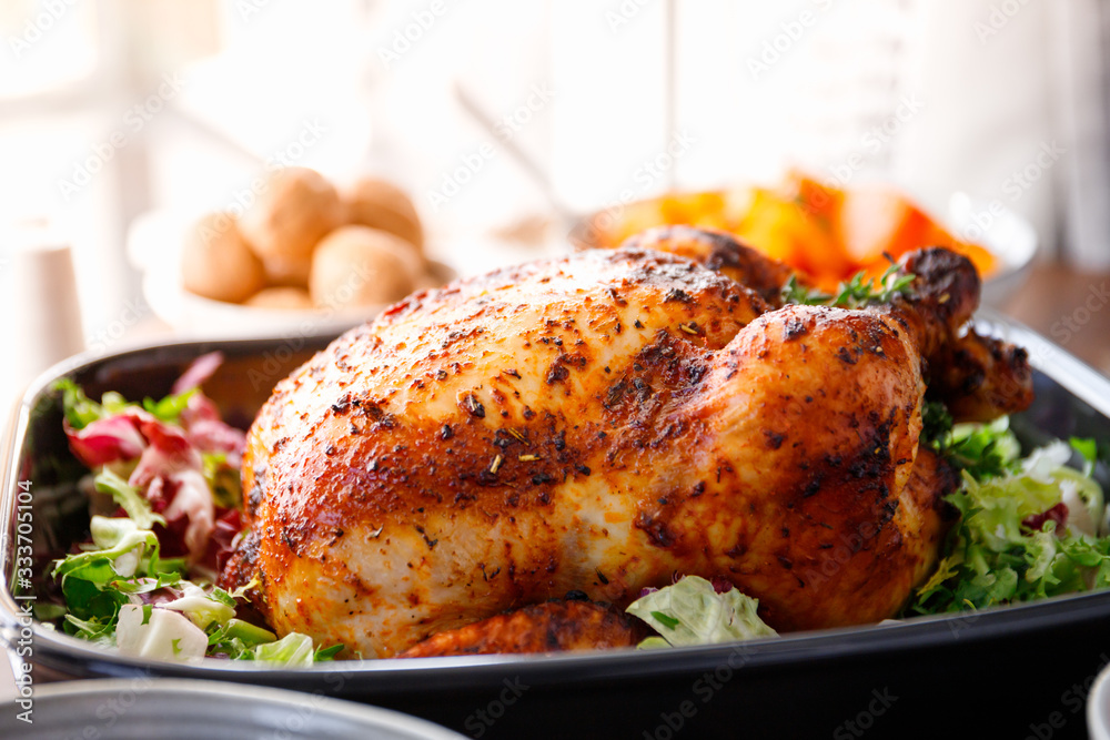 Wall mural whole roasted chicken with fresh salad in black dish