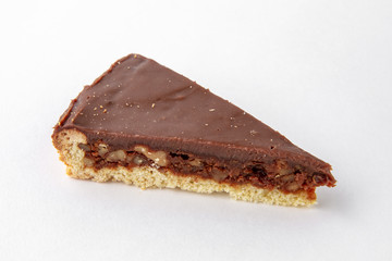 Dessert slice of chocolate cake in a paper plate for take away or food delivery isolated on a white background.